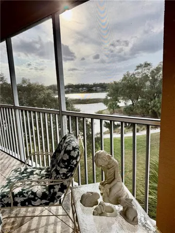 Balcony with a sunroom and a water view