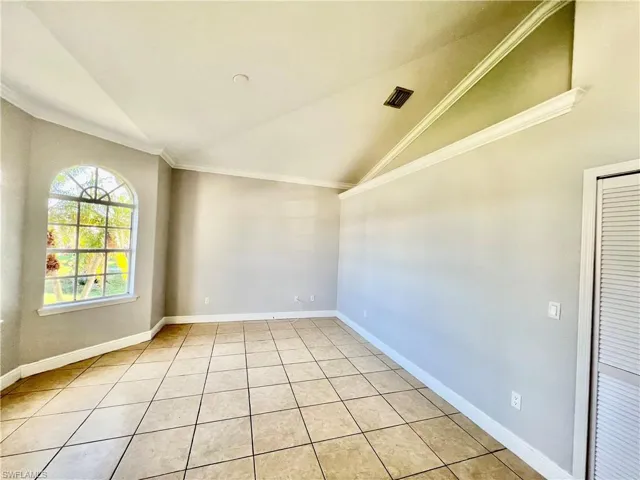 Formal living room in the front with crown molding and vaulted ceilings.