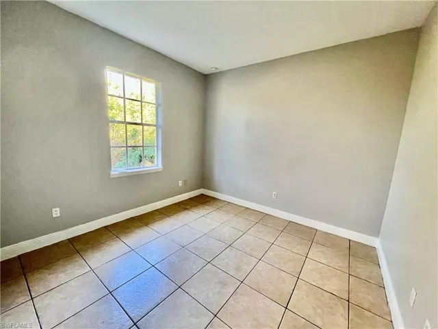 Guest bedroom with tile floors.
