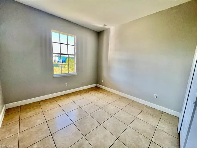 Guest bedroom with tile floors.