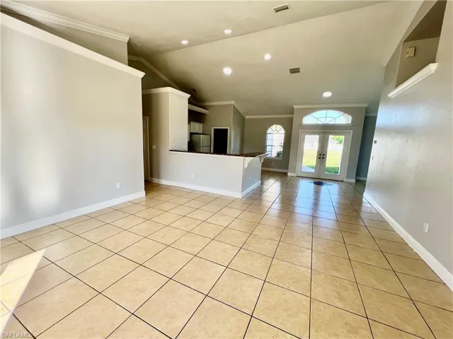 Family room featuring cathedral ceilings and crown molding.