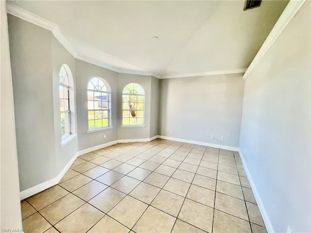 Formal living room in the front with crown molding and vaulted ceilings.