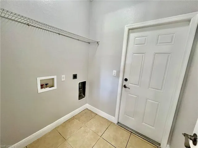 Laundry room featuring washer hookup, light tile patterned floors, and electric dryer hookup