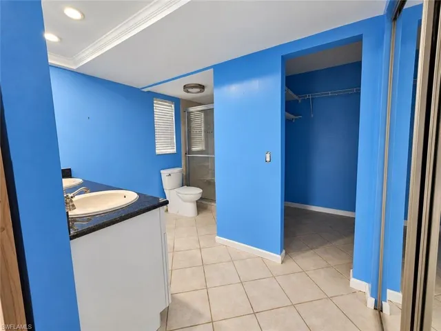 Dual vanity with undermount sinks, stone-look countertop, and built-in cabinetry