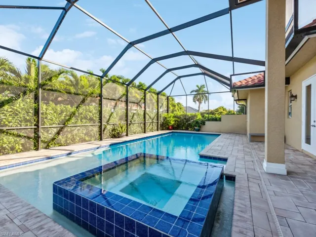 Oversized heated saltwater pool with 360° vanishing-edge spa