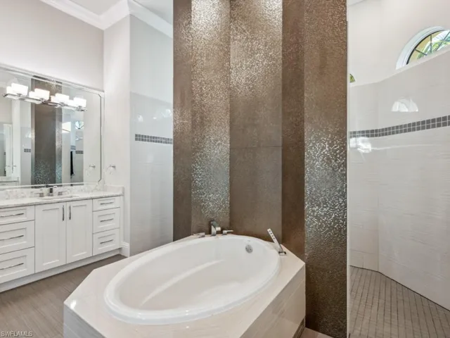 Luxurious primary bath with walk-through shower, 2 showerheads, soaking tub