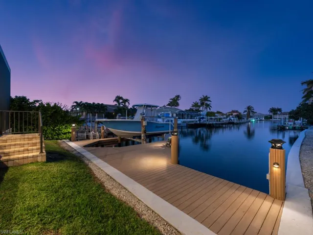 Newer seawall (2017), Captain’s wrap around dock (up to 27’ boat, 10K Lift) plus kayak lift