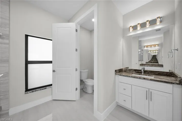 Bathroom featuring toilet and vanity