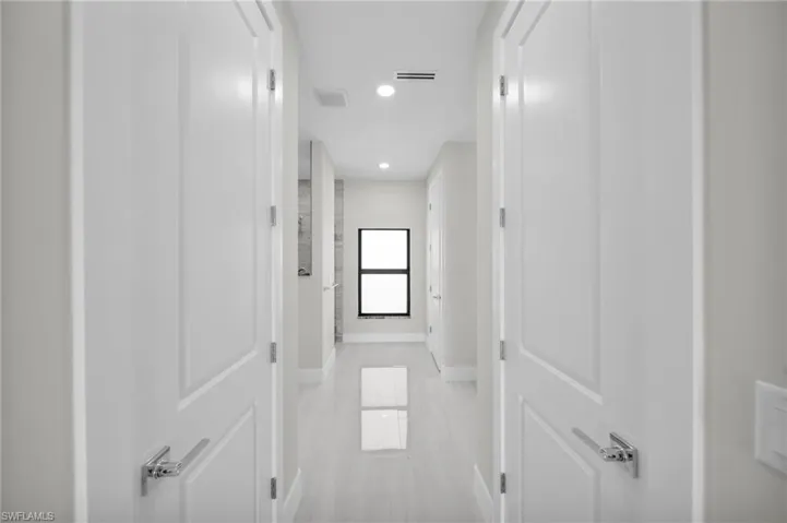 Hall featuring baseboards and recessed lighting
