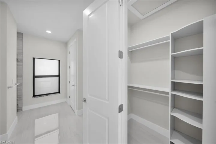 Walk in closet featuring attic access