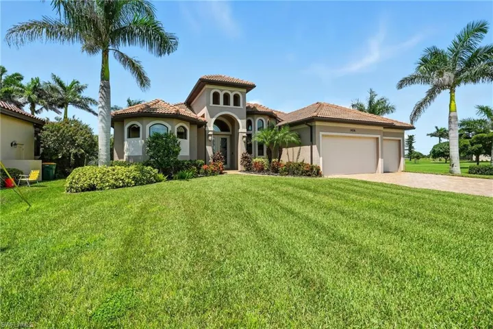 Mediterranean / spanish home featuring a front lawn, stucco siding, decorative driveway, an attached garage, and a tile roof