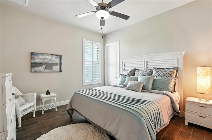 Bedroom featuring wood tiled floors and a ceiling fan