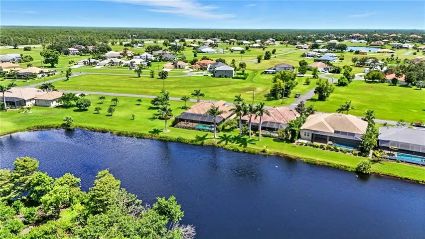 Aerial view of residential area with a large body of water and a golf club