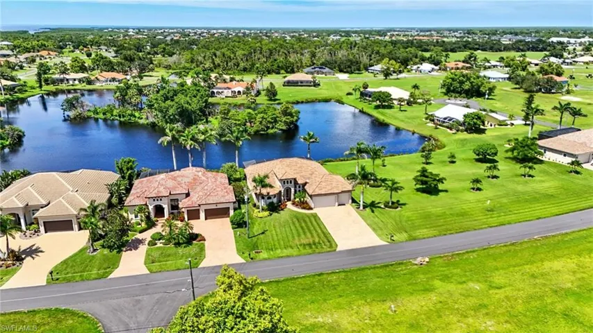 Aerial view of residential area featuring a large body of water