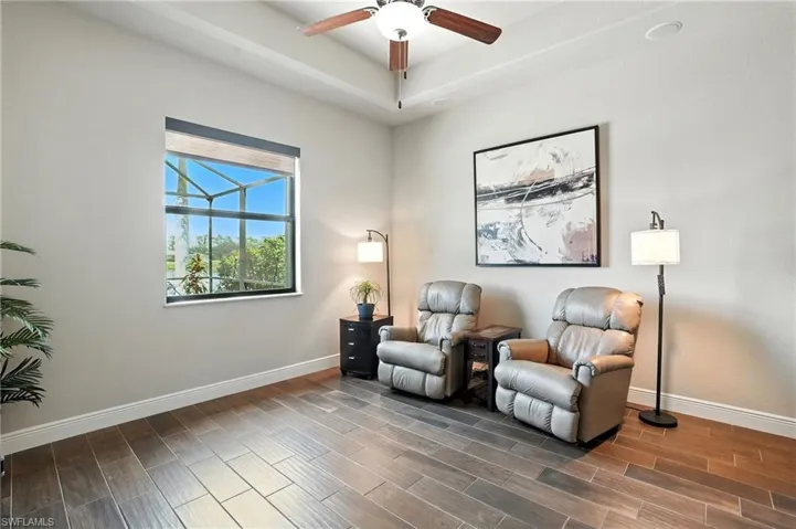 Living area with wood finish floors and ceiling fan
