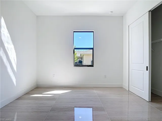 Unfurnished bedroom with baseboards