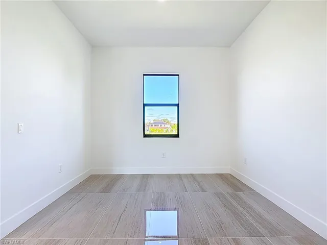 Spare room with baseboards and light wood-style flooring