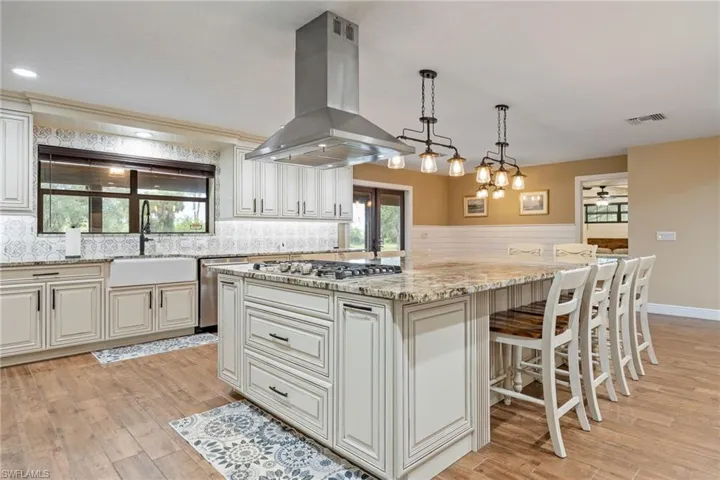 Kitchen featuring storage cabinetry under island on both sides