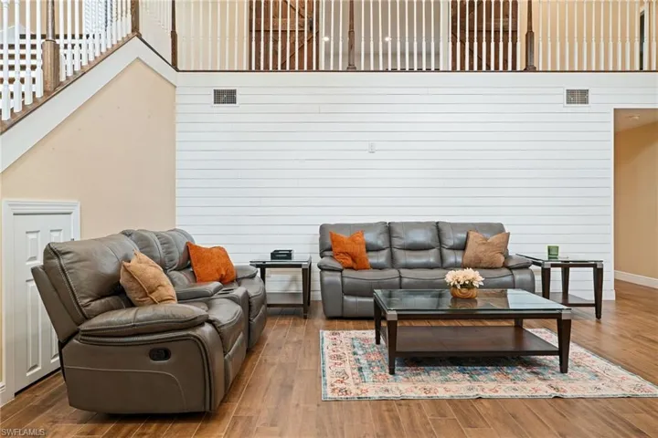 Living room featuring tile floors and wood walls