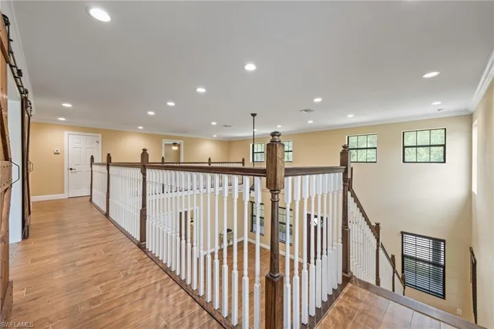 Hallway with an upstairs landing, a barn door,