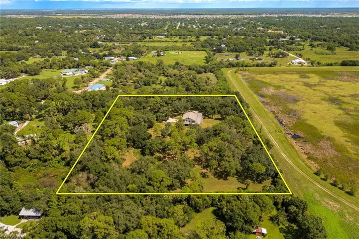 Aerial view of property and surrounding area with property parcel outlined