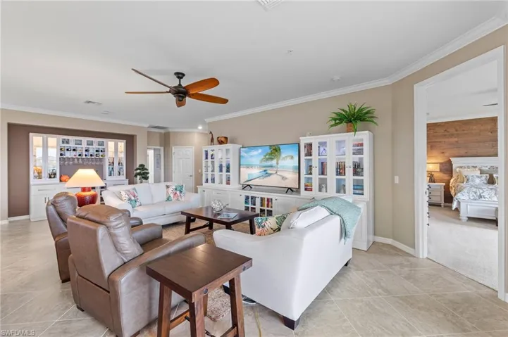 Great room has vertical cellular shades with white-light filtering material.
