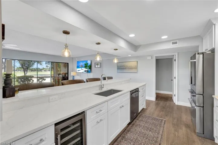 Built In Wine Cooler, Soft Close Cabinetry, Quartz, Large Chef Sink, Raised Island Breakfast Bar