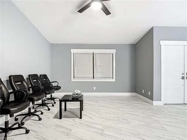 Office featuring light marble finish flooring and ceiling fan