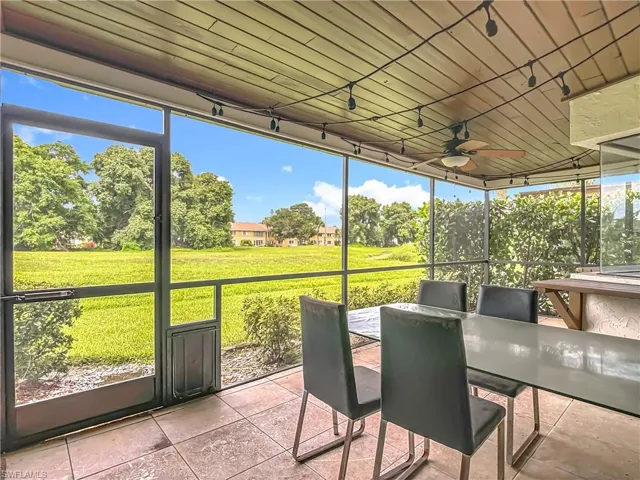 Sunroom / solarium with ceiling fan and outdoor dining space