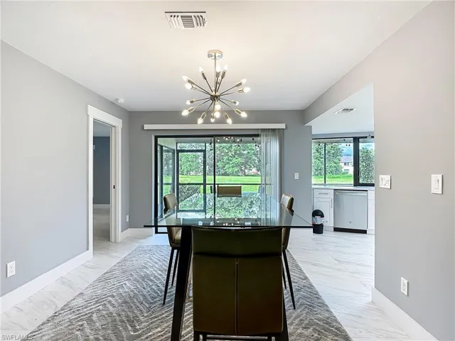 Kitchen with light marble finish floors, healthy amount of natural light, and stainless steel dishwasher