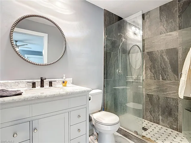 Full bath with walk in shower and vanity