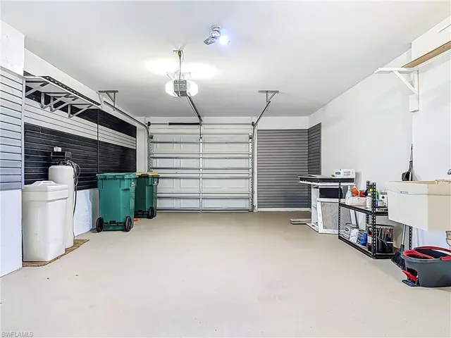 Garage featuring a garage door opener and a sink