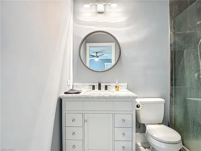 Full bathroom featuring vanity and a stall shower