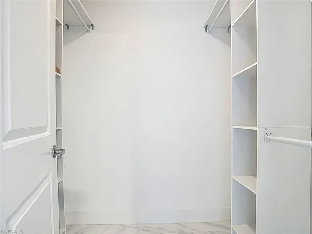 Spacious closet with light marble finish flooring