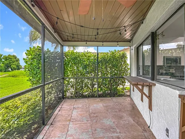 Unfurnished sunroom featuring ceiling fan