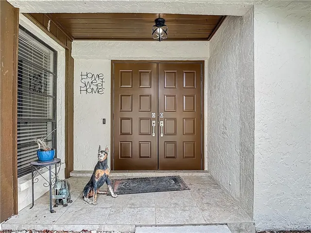 Doorway to property with stucco siding