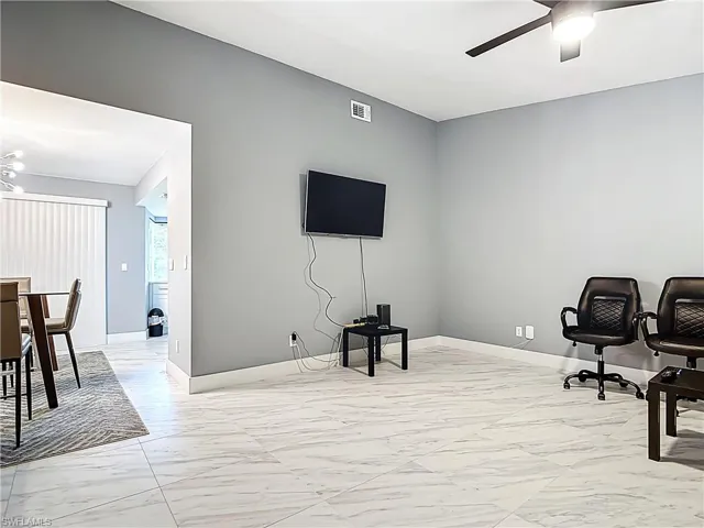 Office space featuring light marble finish flooring and a ceiling fan
