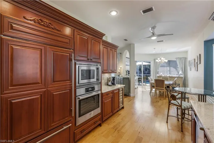Custom cherry cabinets with paneled front Subzero refrigerator, granite countertops and wine fridge