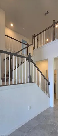 Staircase featuring baseboards