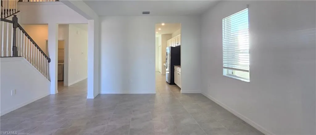 Unfurnished room featuring stairs and washer / dryer