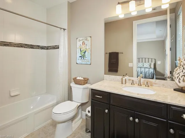 Full bathroom featuring tile patterned flooring, vanity, shower / bathtub combination with curtain, and toilet