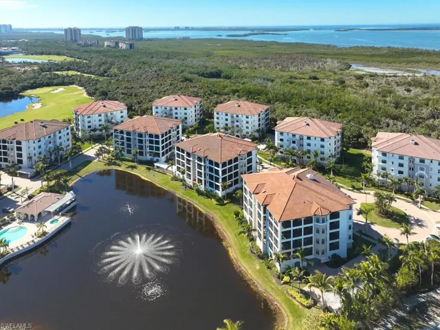 Birds eye view of property with a water view
