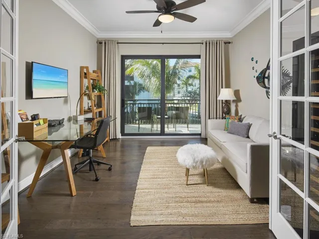 Office featuring crown molding, dark wood-type flooring, french doors, and ceiling fan
