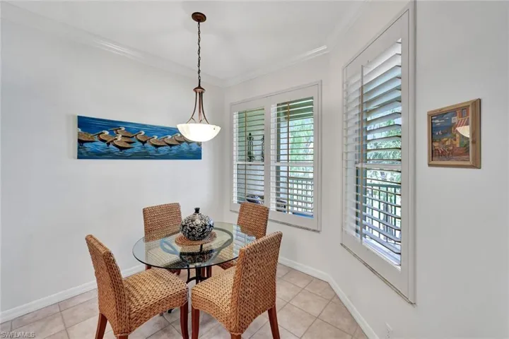 Dining room featuring crown molding and light tile patterned flooring