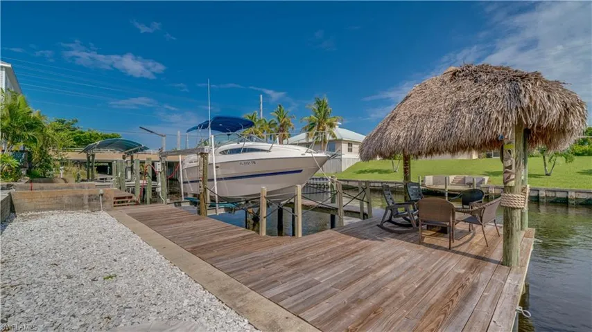 Dock area featuring a yard and a water view