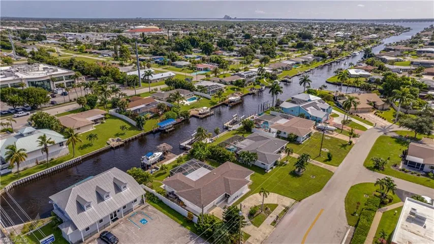 Birds eye view of property with a water view