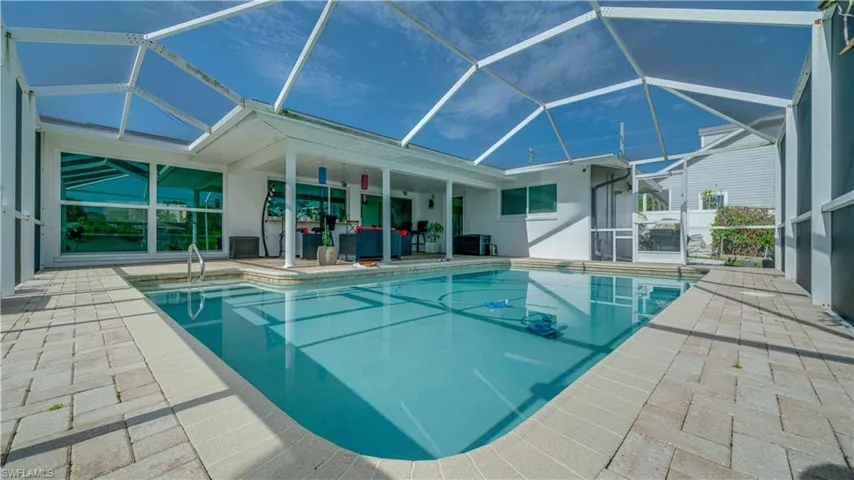 View of heated pool featuring a patio area and a lanai