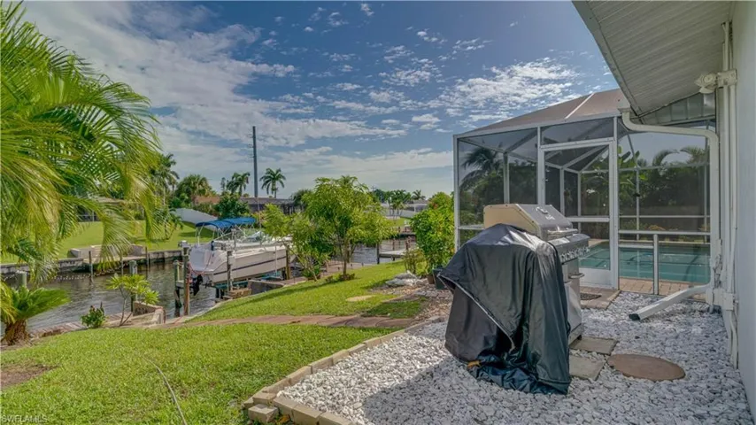 View of yard featuring a lanai and a dock