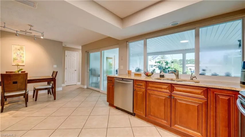 Kitchen with pass through window and sliders to pool area