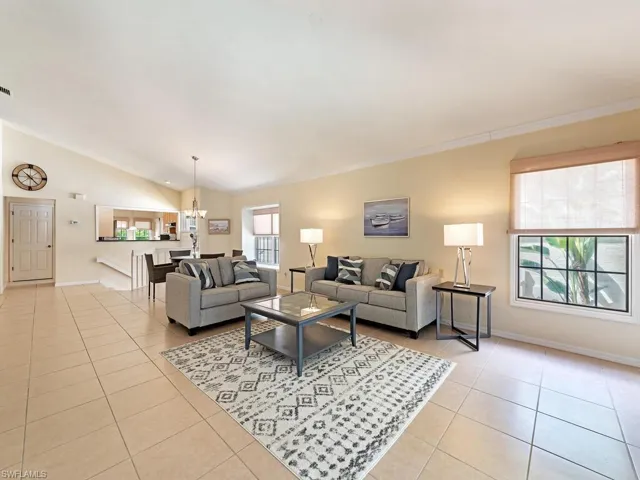Spacious great room with ceramic tile flooring, plenty of light, vaulted ceilings with crown moldings.